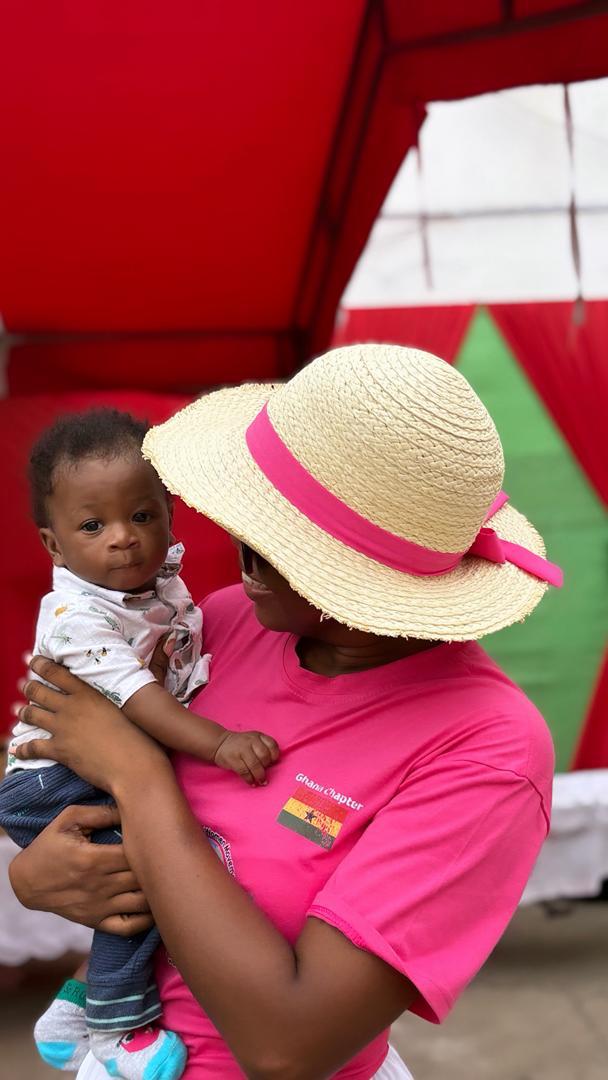 A mother holding her baby at the outreach event